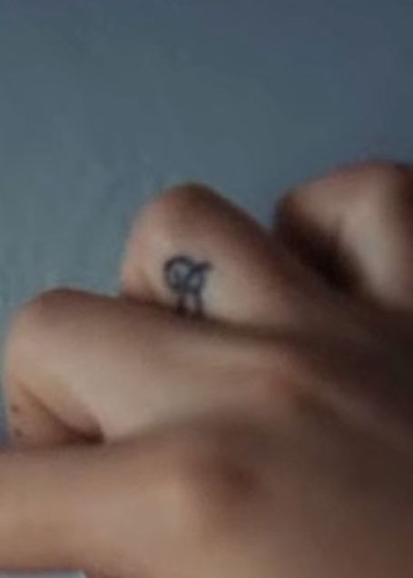 bergoli's left hand with the B tattoo in between her hand 